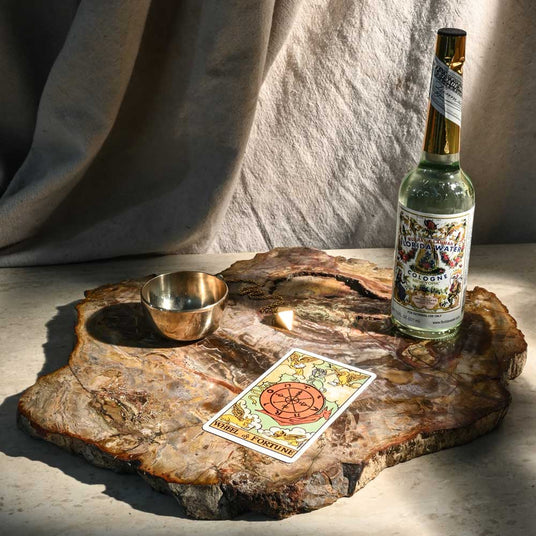 Bottle of fragrance / ritual water and a tarot card.